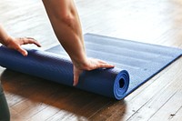 Rolling up a yoga mat after class