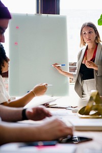 Businesswoman writing on a board in the meeting room