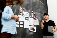 Startup team brainstorming in meeting room using blackboard