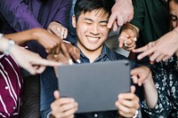 Group of diverse business people watching a content on a digital tablet together