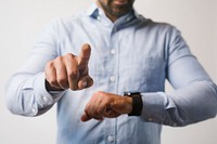 Man in a blue shirt using his smartwatch