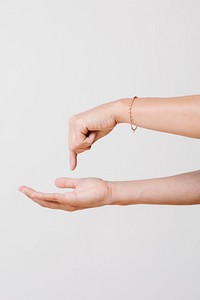 Woman pressing her finger to her own palm