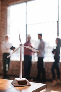 Eco-friendly engineering team standing by a the glass window