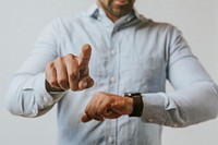 Man in a blue shirt using his smartwatch