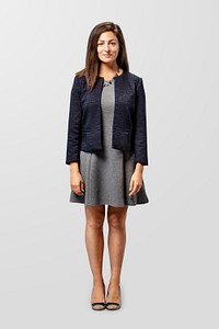 Happy businesswoman standing by a gray background
