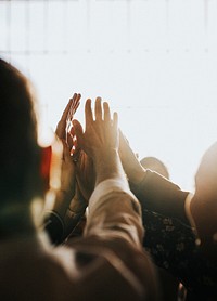 People joining hands in the air