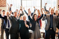 Cheerful businesspeople raising hands in the air