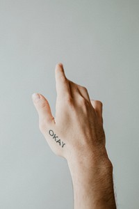 Okay word tattooed on a hand
