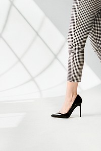 Fashionable woman in black shiny heels