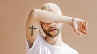 Blond man with a cross tattoo on his arm wallpaper