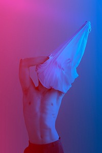 Man taking off his shirt with pink and blue filter effect