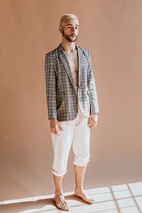 Bearded man in a plaid shirt and white pants
