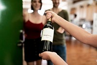 Woman presenting a bottle of red wine