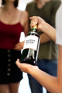 Woman presenting a bottle of red wine mockup