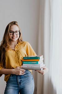 Cheerful blond girl carrying books