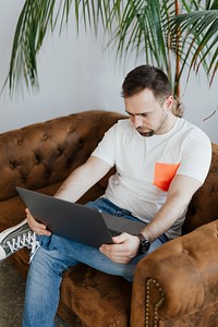 Man on the couch working on his laptop