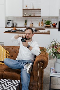 Photographer sitting on the couch looking at images