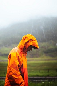 Woman in waterproof jacket while trekking in the highlands