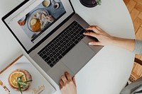 Woman looking at baking recipes on her laptop
