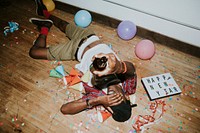 Man laying down on the floor at a party