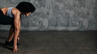 Afro woman getting ready to run