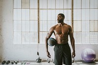 Shirtless muscular man holding a fitness ball