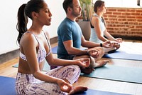 Diverse people meditating in a yoga class