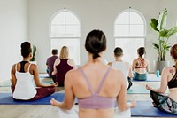 Healthy people making a Sukhasana yoga pose in yoga class