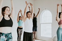 Group of people doing full body stretching in a class