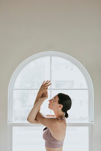 Fitness woman in a arudasana pose