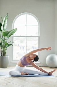 Fitness woman in a Parivrtta Janu Sirsasana pose