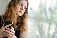 Stressed woman with her smartphone