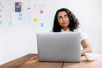 Skeptical businesswoman using a laptop