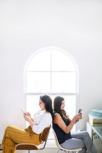 Businesswomen using their mobile phones