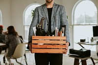 Man carrying a wooden box in the office 