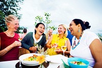 Female friends having dinner by the beach