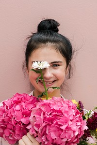 Beautiful young girl with a large pink bouquet