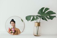 Reflection of a beautiful young girl with flowers