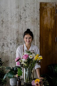 Young florist making a beautiful flower arrangement