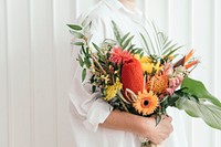 Woman holding a colorful tropical bouquet