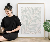 Cute girl with a laptop sitting by a frame mockup