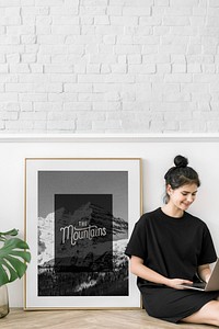 Cute girl with a laptop sitting by a frame mockup