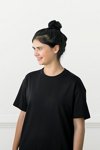 Portrait of a cheerful girl in a black tee over a white background