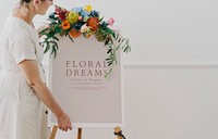 Woman standing by a floral dreams frame mockup