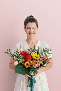 Smiling woman holding a tropical bouquet
