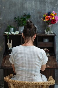 Woman sitting by an old wooden desk