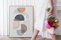 Woman holding a bouquet while walking past a frame mockup