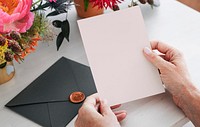 Woman reading an invitation card mockup