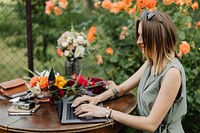 Woman working on her laptop in the garden