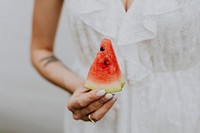 Woman holding a slice of watermelon